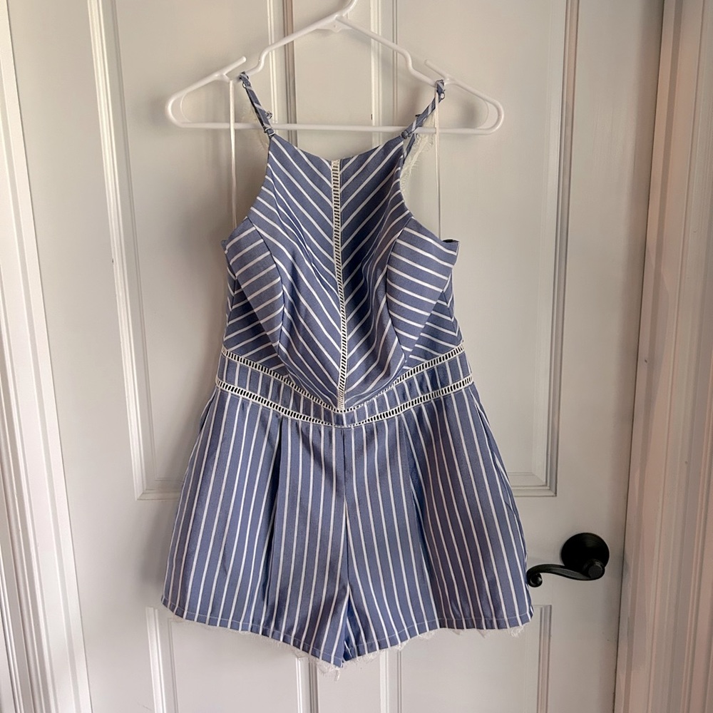 Light blue romper with white stripes and lace accents